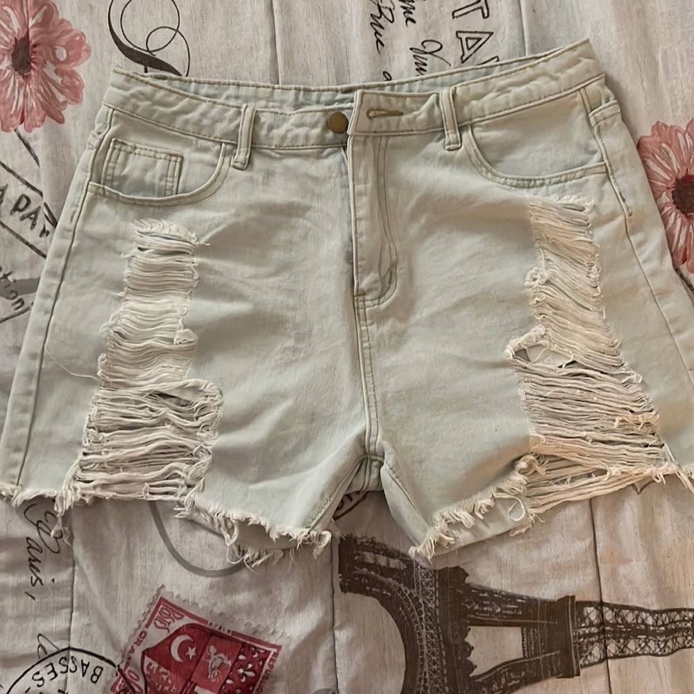 Light blue jeans with rips front and back